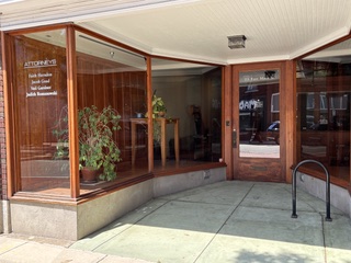 the entryway to Romanowski Law sits in a brick building with large windows